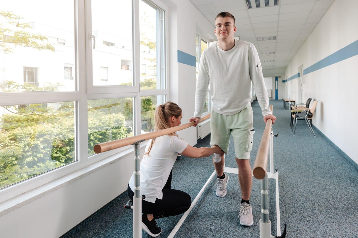 A young man going through physical therapy as he recovers from a personal injury.
