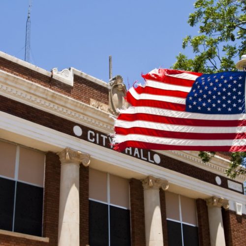 City Hall And American Flag Stock Photo