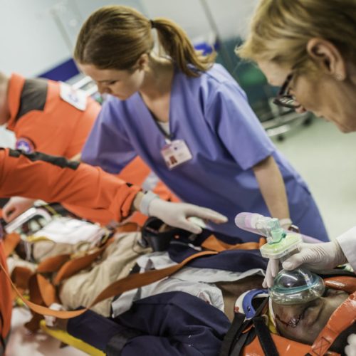 Paramedics Treating Patient Stock Photo